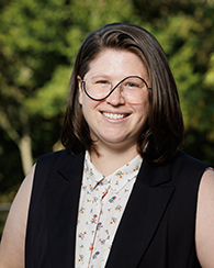 headshot of a faculty member with medium length brown hair and glasses